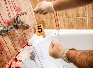 Forensic police take blood samples in a bathroom at the murder scene, conceptual image