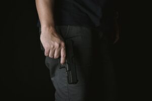 Man holding gun close to the body