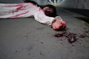 Scary woman in white dress with bloodstain after murder, Halloween concept