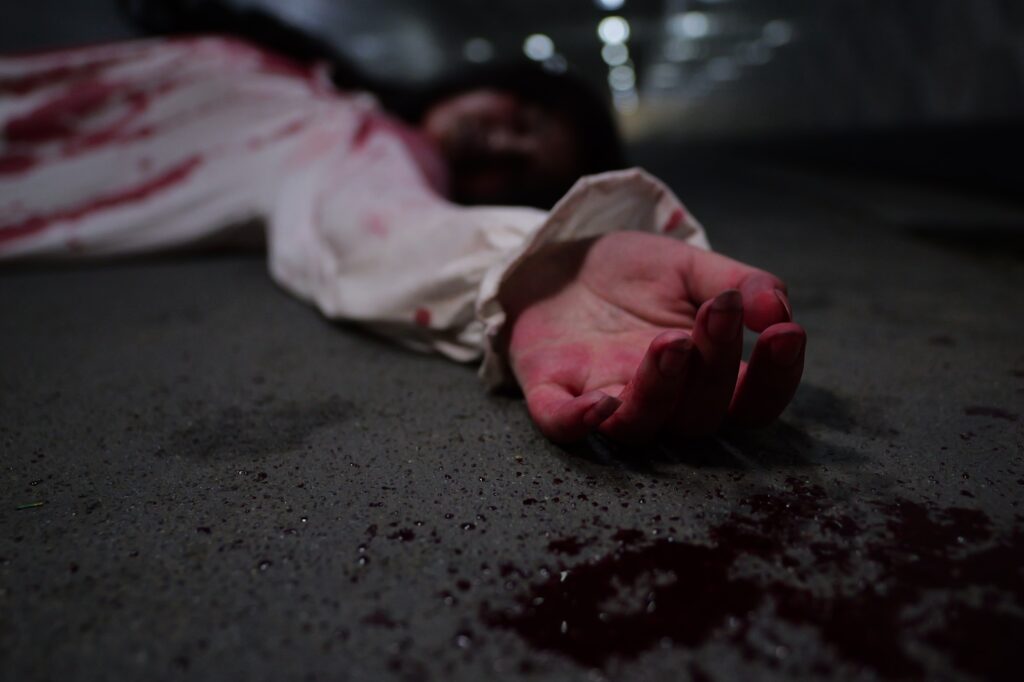 Scary woman in white dress with bloodstain after murder, Halloween concept