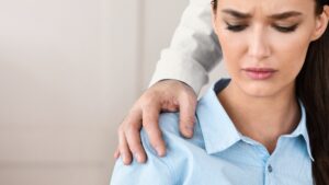 Businesswoman Victim Of Sexual Harassment Sitting In Office, Cropped