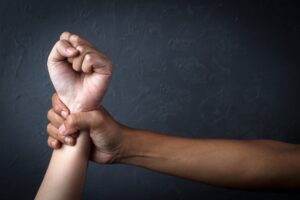 Man's Hand Holding A Woman Hand, Sexual Abuse And Rape Concept