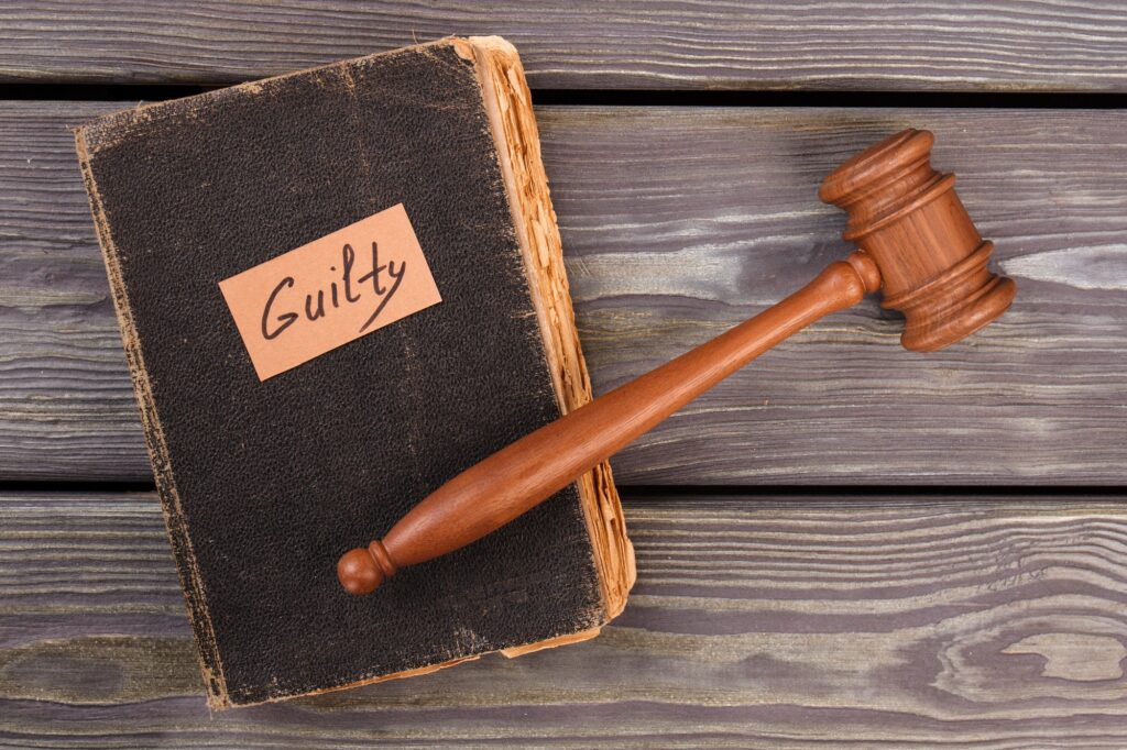 Old book gavel and guilty verdict.
