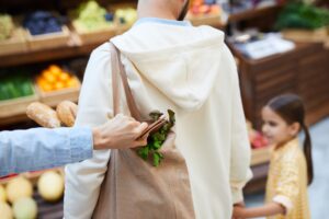 Thief getting purse out of shopping bag