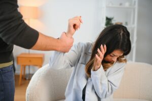 Man beating up his wife illustrating domestic violence