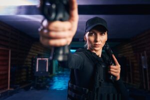 Focused attractive woman firing from two handguns