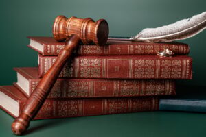 Law gavel and wedding rings on table
