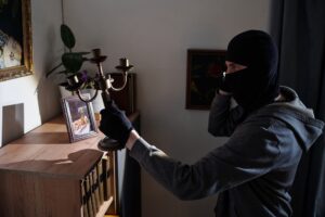 Masked Man Stealing Candlestick during Burglary