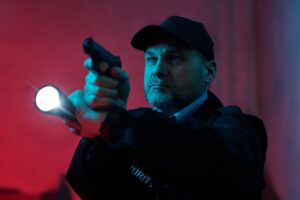 Security guard with flashlight and gun
