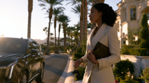 African American woman standing beside a parked SUV on a Las Vegas street while learning about Nevada open container laws.