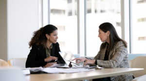 Nevada defense attorney discussing legal documents with a client facing an out-of-state warrant and possible extradition in Las Vegas.