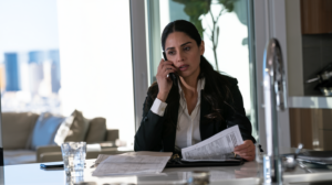 Woman reviewing legal paperwork during a phone consultation about an out-of-state warrant and extradition process in Las Vegas.