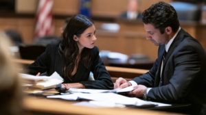 Nevada criminal defense attorneys reviewing court documents during a hearing involving smartphone evidence and search warrant issues.