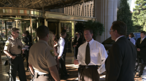 Attorney speaking with law enforcement outside a Las Vegas property while discussing a criminal investigation involving digital evidence.