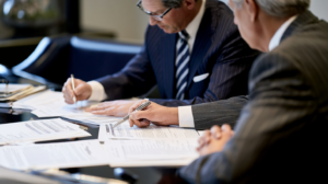Attorneys reviewing a Nevada pardon application and legal documents for restoration of firearm rights.