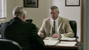 Legal professional discussing case documents during a consultation involving alleged indecent exposure or lewdness charges in Nevada.