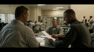 Nevada correctional staff reviewing records with an incarcerated person during the prison intake and classification process.