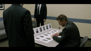 Investigators reviewing photographs during an eyewitness identification process in a Nevada criminal investigation.