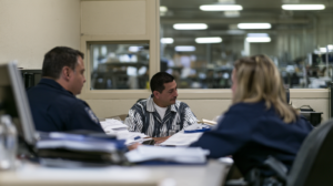 Nevada correctional staff reviewing documents with an incarcerated person to determine classification and prison placement.