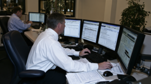 Financial investigator reviewing benefit applications and electronic records related to suspected unemployment or insurance fraud in Nevada.