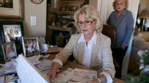 Woman reviewing financial and family records connected to concerns involving an older relative in Nevada.