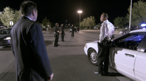 Law enforcement officers at a nighttime Nevada investigation scene where eyewitness information may be collected.