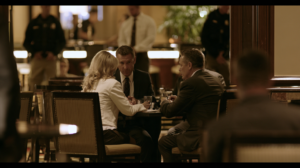Investigators meeting inside a Las Vegas venue during an investigation involving possible pandering or sex trafficking offenses.